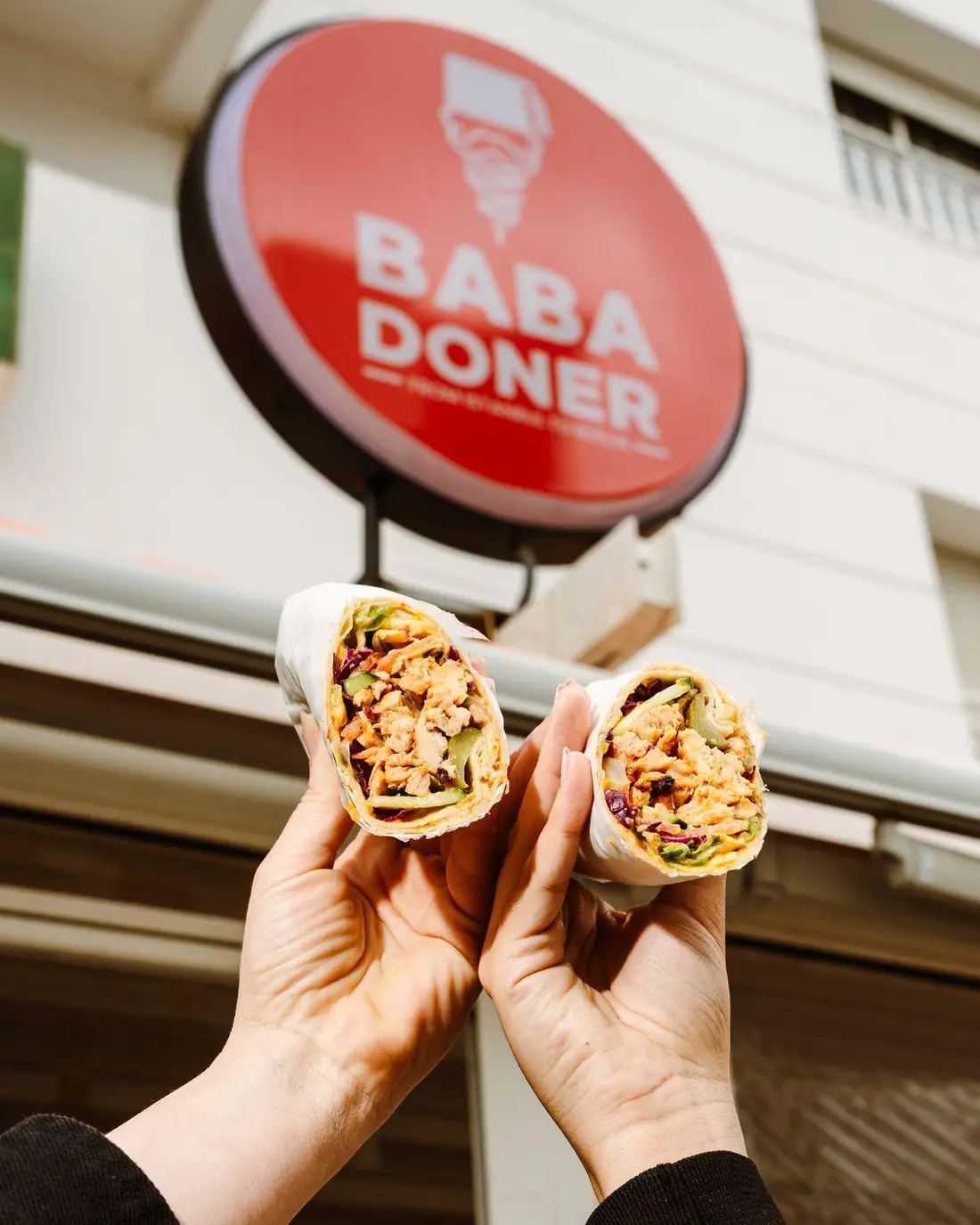 Two wraps held up under the shop sign