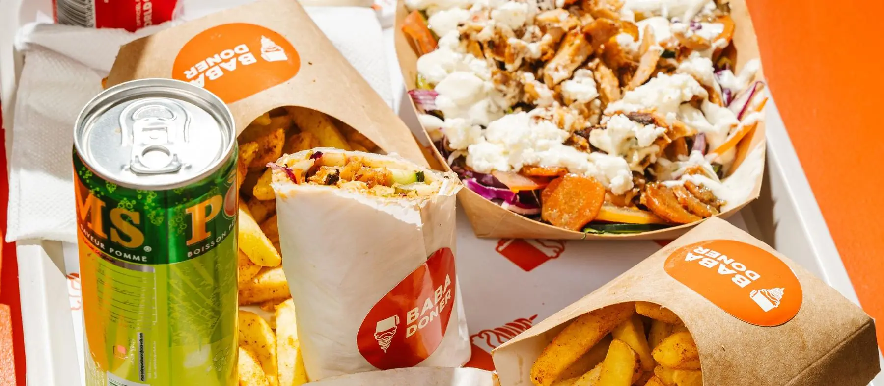 Baba Doner meal on a tray: wrap, fries, a loaded box and branded packaging
